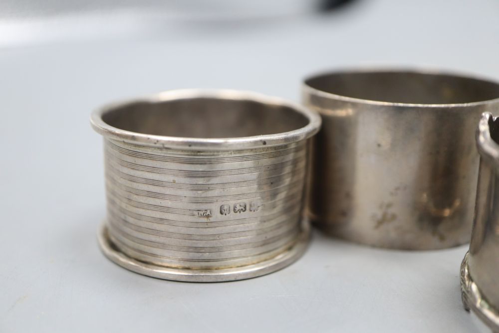 Five assorted silver napkin rings including a pair, a silver cigarette case and button hook, 7oz.